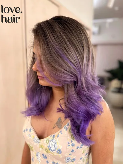 A side view of the ash brown and purple blend, showing the client's tattoo peeking through.
