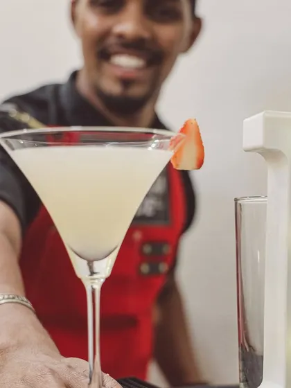 A happy client with their signature birthday cocktail. My bartender is all smiles after helping create a special drink for the occasion, showing the friendly, personalized service you can expect.