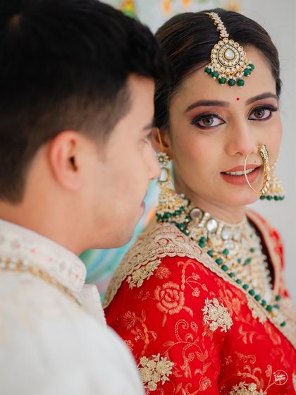 A close-up capturing the bride's stunning details and her loving gaze towards her partner. This intimate shot from their Udaipur wedding highlights the emotion and beauty of the moment.