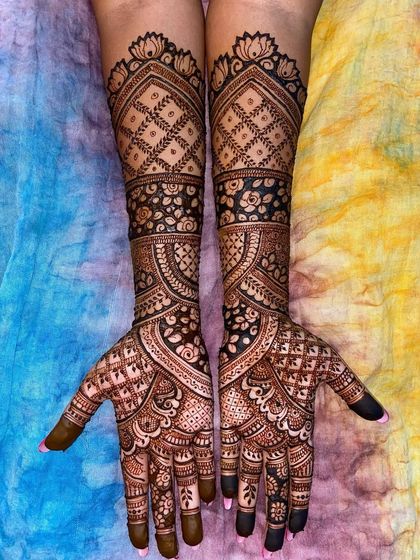 A beautiful full-arm design with a mix of floral and geometric patterns, set against a colorful background.