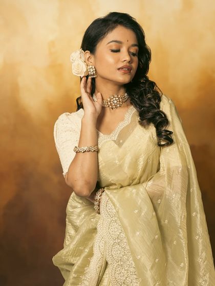 A beautiful side profile, showing the floral hair accessory and the elegant line of the choker.