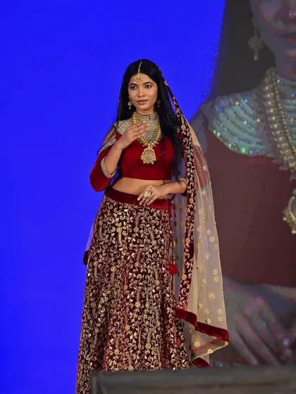 On the runway for a jewelry show, this look features a dramatic red lehenga. I created a complementary makeup look with warm, golden tones and defined eyes to match the traditional opulence.