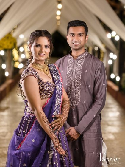 A beautiful sangeet look, with the bride's semi-bridal mehendi perfectly complementing her purple lehenga.