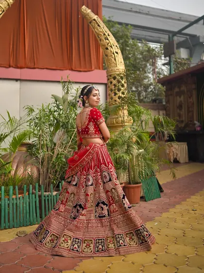 A side profile showcasing the beautiful silhouette of the lehenga and the elegant hair bun. The makeup is subtle, ensuring the focus is on her overall grace.