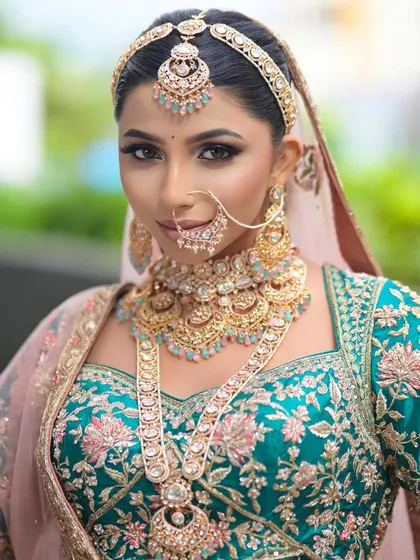 A close-up of the modern bridal look, showcasing the intricate gold jewelry and the flawless makeup application. The eyes are the star of this look.