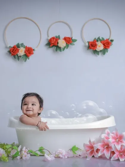 A wider shot of the bubble bath setup, showing the clean, simple background and floral accents that create a sweet and charming scene.