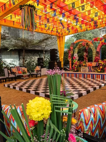 The dance floor and stage for the carnival event, featuring a checkered floor and a colorful, multi-layered backdrop.