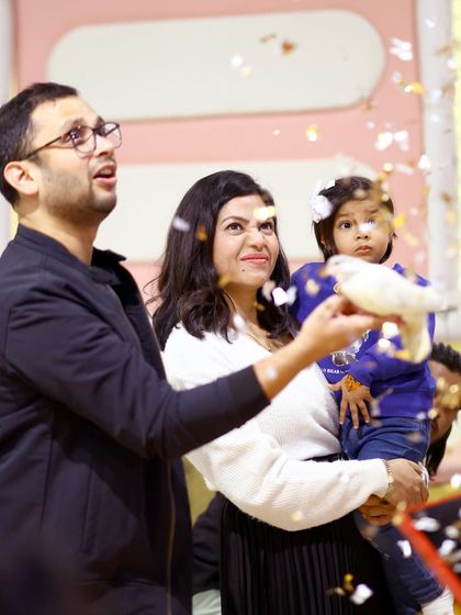 A family is surprised and delighted by a magic trick during their jungle-themed celebration. These shared moments of wonder are what make our parties so special.
