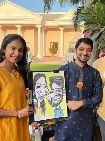 A lovely couple posing with their caricature at a wedding in Ambegaon, Pune. Couple caricatures are a popular request and a wonderful keepsake for partners.