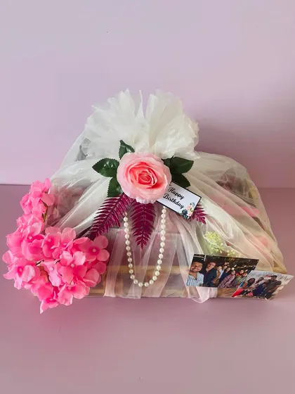 The net-wrapped wooden tray hamper, showing the custom "Happy Birthday" tag and the personal photos I can add.