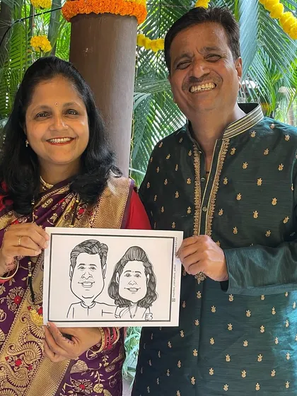 A happy couple with their caricature souvenir at a beautiful wedding in Thane. Our live sketching is a perfect way to entertain guests and give them a personal memento from your special day.