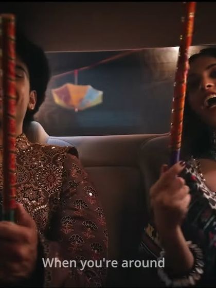 A fun in-car shot of the friends heading to a Garba night, showing off the festive mirror-work jackets and jewelry I styled.