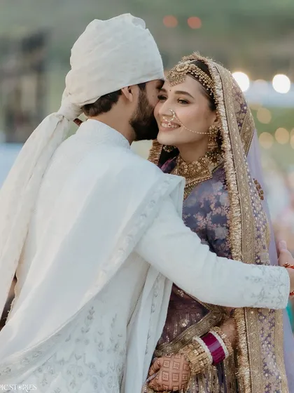 A sweet and tender moment between the newlyweds. Yash's gentle kiss on Riti's cheek is a perfect, quiet end to a beautiful wedding ceremony, filled with love and promise.