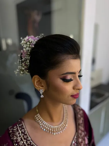 A stunning bridal updo with delicate baby's breath, paired with a glamorous smokey eye and bold lip. Our course covers both hair and makeup for a complete bridal look.