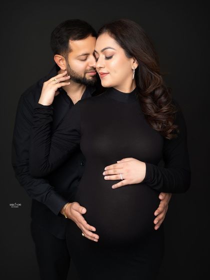 A close, intimate portrait against a dark backdrop. This moody lighting really emphasizes the emotional connection between the couple.