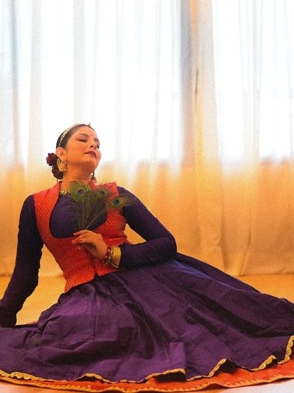 A moment of quiet devotion to Lord Krishna. This seated pose with peacock feathers captures the essence of surrender and love that is central to 'bhakti'.