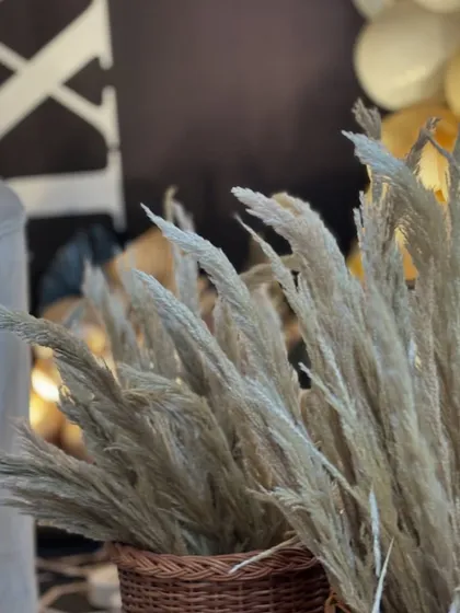 More details of the pampas grass in wicker baskets, contributing to the modern-boho aesthetic of the birthday party.