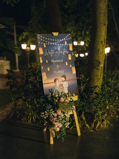 A personalized welcome easel with a cute caricature of the couple, adding a whimsical and personal touch to the reception.