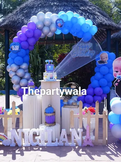 An outdoor Boss Baby party setup under a gazebo. The blue, purple, and silver balloons look great in the natural light, showing the versatility of my decorations.