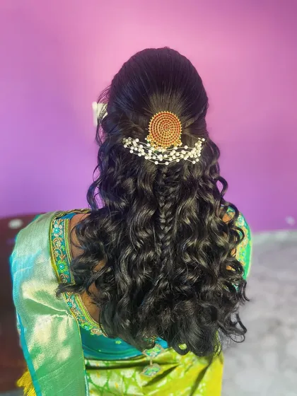 A detailed view of the hair accessory and the central fishtail braid.
