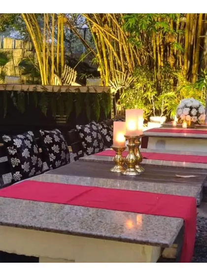 A closer look at the table setup for an evening event, with elegant red runners and candleabras. Our team ensures every detail of the table setting is perfect before guests arrive.