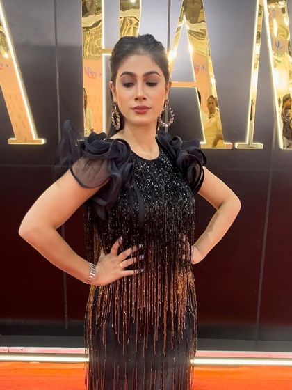 Posing for the camera. The makeup is designed to look stunning under the bright lights of an event.