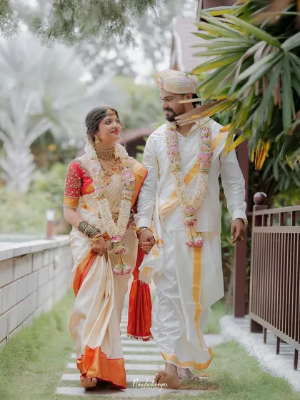 A candid shot of the couple walking and sharing a look of love. This captures their natural chemistry and the happiness of their wedding day.