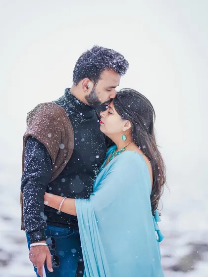 An emotional close-up portrait during a gentle snowfall in Kashmir. This image focuses on the quiet, tender moments that define a couple's connection, showcasing our ability to capture pure emotion.