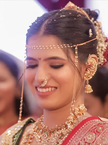 A beautiful, happy moment. The makeup is soft and subtle, focusing on enhancing her natural beauty.