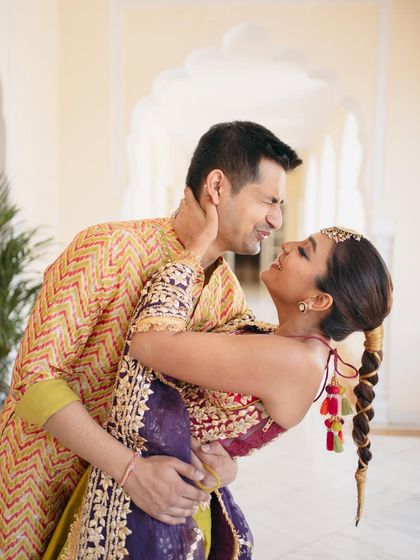 A playful dip! This action shot shows how a well-set hairstyle, like Mishi's accessorized bubble braid, can handle all the fun and dancing of a wedding celebration.