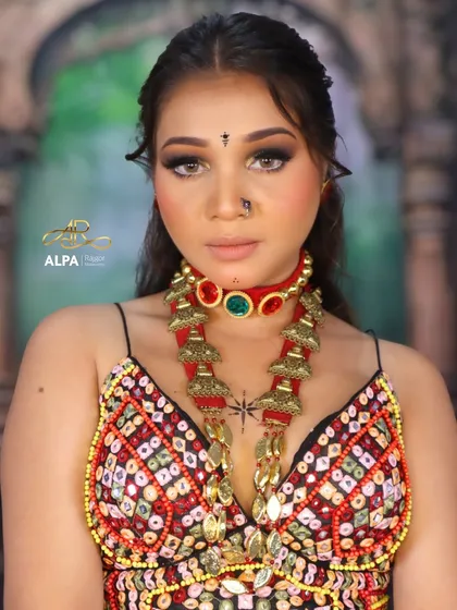 A direct portrait showing the intensity of the smokey eyes and the traditional bindi and nose pin. The makeup is powerful yet clean.