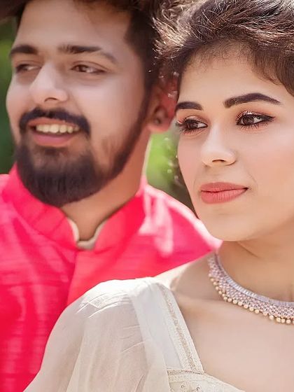 A beautiful close-up focusing on the bride's serene expression, with the groom slightly behind her. The warm, natural light highlights her features and the intricate details of her jewelry.