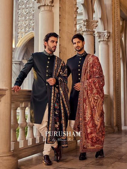 Another view of these regal bandhgalas. The rich shawls add a layer of texture and history, perfect for a formal evening event or a winter wedding.