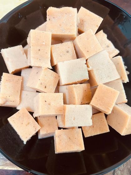 Cubes of my peach-colored lentil tofu, ready to be tossed into a fresh salad. It’s a simple and effective way to add a complete protein to your daily meals.