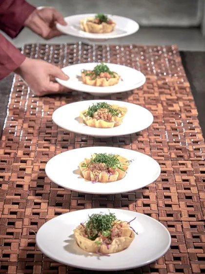 Service is an art form. Our professional team ensures every dish, like these beautifully arranged appetizers, is presented with grace and precision, allowing you to relax and enjoy the experience as much as your guests.