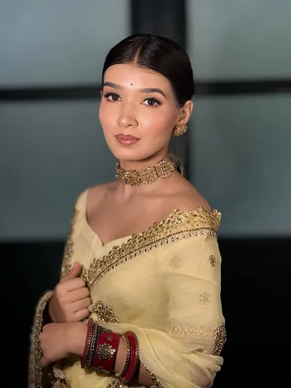 A full shot of the model in the yellow saree, showing how the minimal makeup complements the entire outfit.
