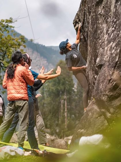 Teamwork makes the dream work. Here, our crew is focused on spotting a climber as she navigates a tricky bouldering problem in Sethan. We always prioritize safety and mutual support.