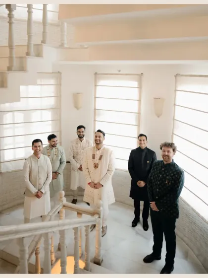 A well-composed shot of the groom with his groomsmen, all looking dapper on a spiral staircase.