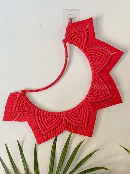 Inspired by the Strawberry Moon, this red crescent moon hanging is a reminder to appreciate how far you've come. It's a unique piece of fiber art that adds a pop of color and a meaningful touch to your space.