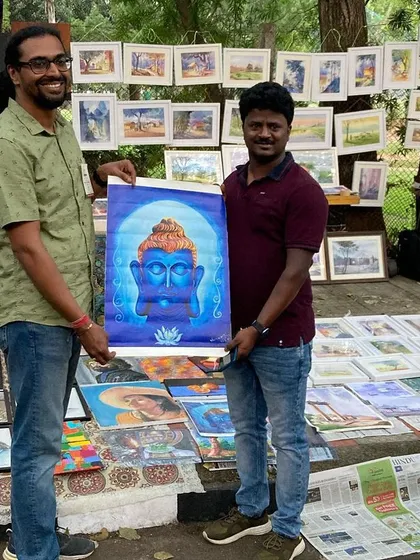 A happy customer with his new painting from my stall.