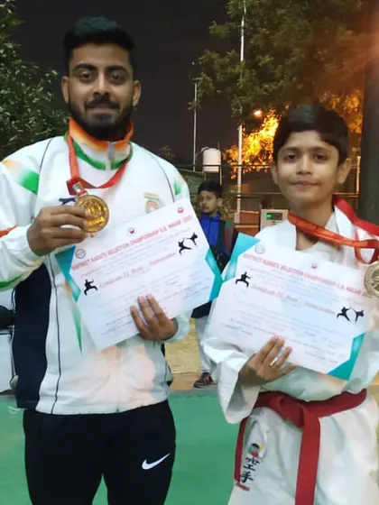 Celebrating the success of our young athletes. Here I am with one of my students who won multiple medals at the district championship, a testament to his hard work and our training methods.