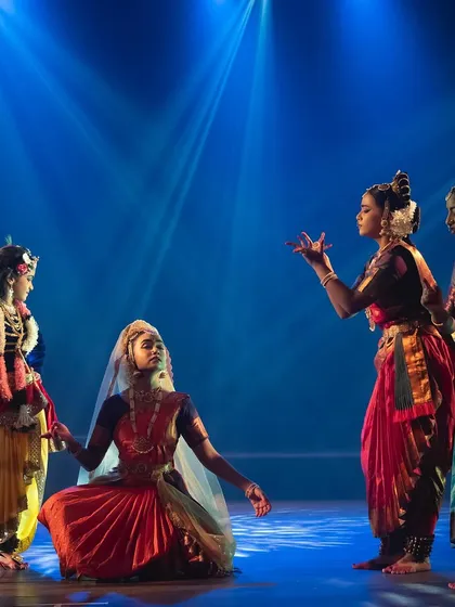 A beautifully composed scene from "KRISHNA". The arrangement of dancers on stage creates a balanced and visually pleasing frame, highlighting our attention to choreographic detail.