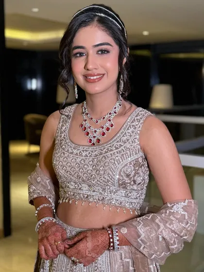 The complete sangeet look, from the elegant headband to the detailed lehenga, all tied together with flawless makeup.