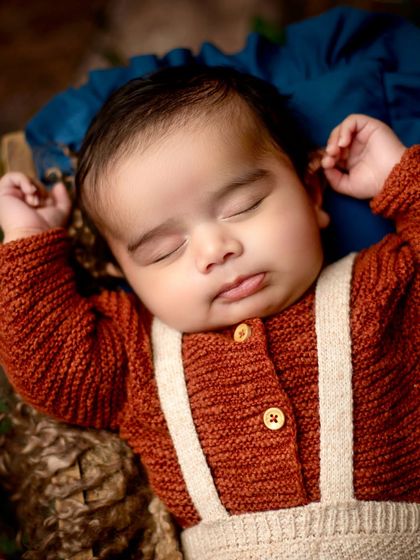 A detailed close-up of the baby's face, capturing his sweet lips and chubby cheeks while he sleeps soundly.