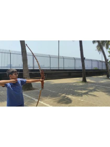 This young archer is fully focused on the target, demonstrating the discipline learned at the camp.