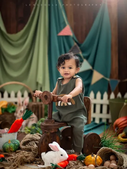 On the move in our rustic farm setup. This little explorer is ready to ride his wooden tricycle through the vegetable patch.