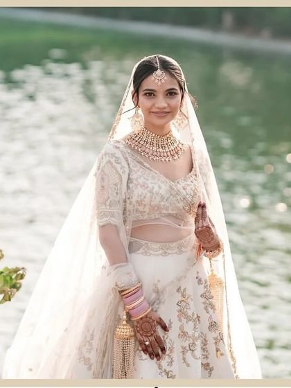Vidha looking like a dream by the water. Her all-white lehenga was paired with a very natural, "no-makeup" makeup look for her day wedding.