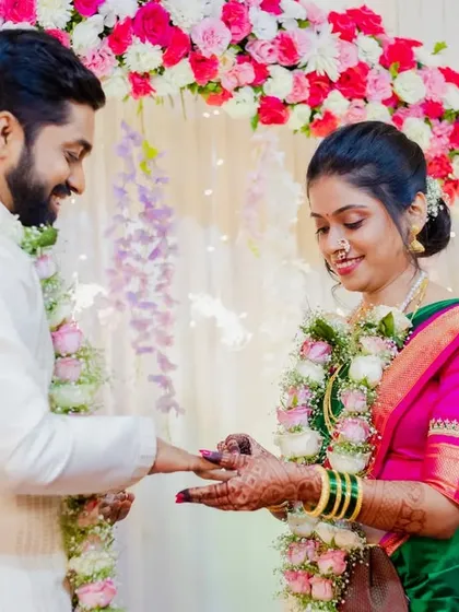 A beautiful shot of Asawari and Amit exchanging rings, framed by a stunning floral arch. This is a key moment I always ensure to capture perfectly.