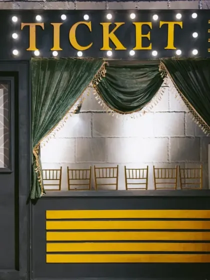 A vintage ticket booth for a Bollywood-themed Sangeet. I use creative props and setups like this to fully immerse guests in the cinematic theme from the moment they arrive.