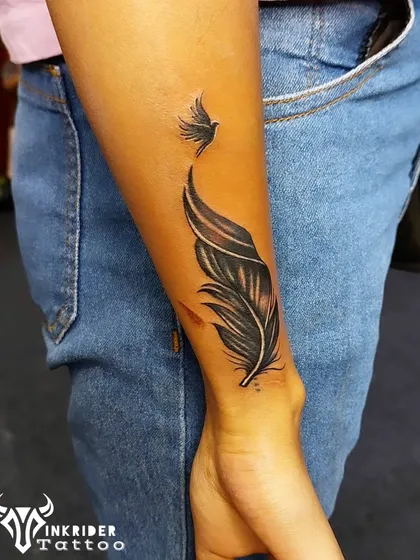 Another successful name cover-up, this time using a feather that transforms into a bird. This design symbolizes freedom and moving on from the past.